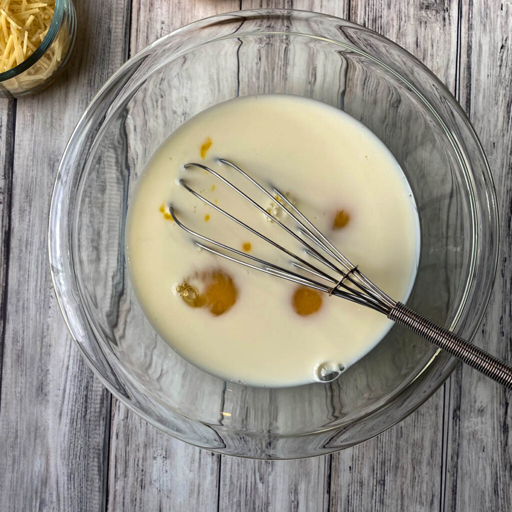 Quiche ingredients in a bowl-eggs, egg whites and milk