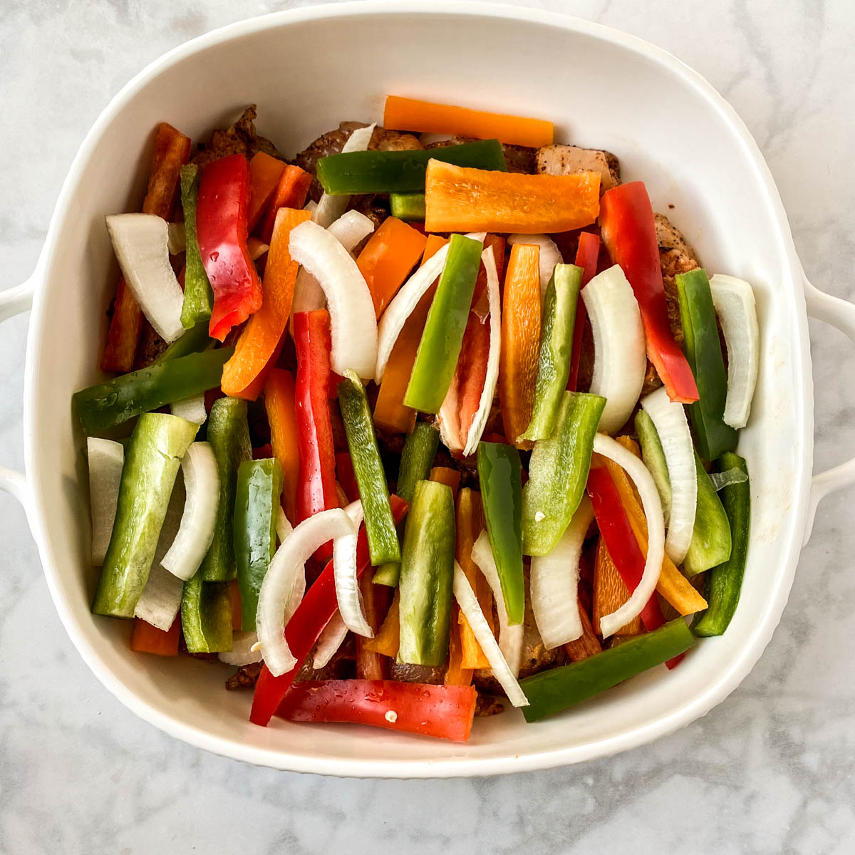 sliced peppers in a casserole dish