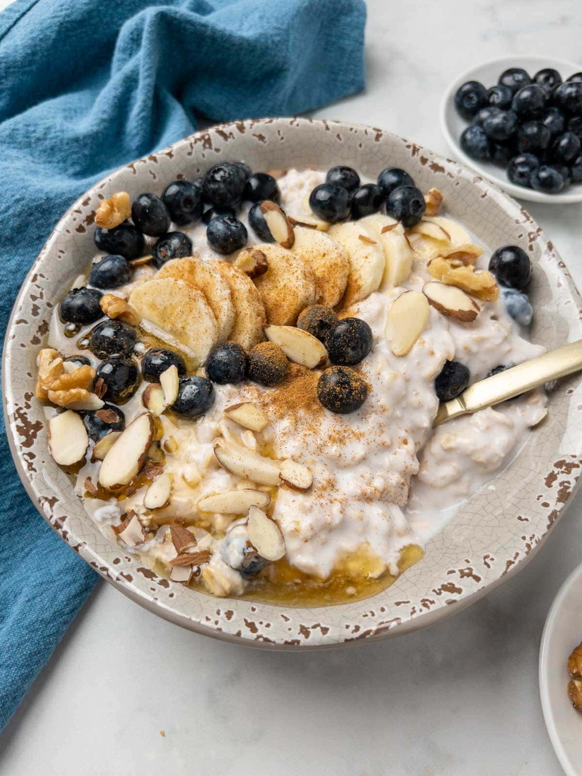 kefir overnight oats in a bowl with bananas and blueberries. 