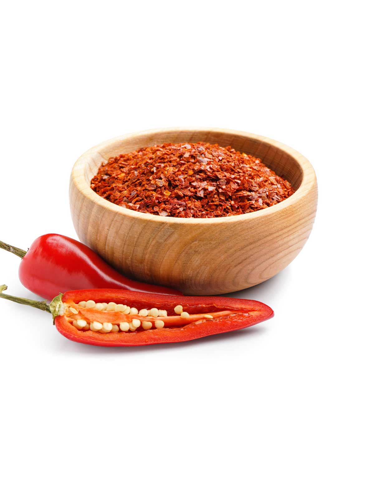 bowl of red pepper flakes with a red pepper sitting next to them