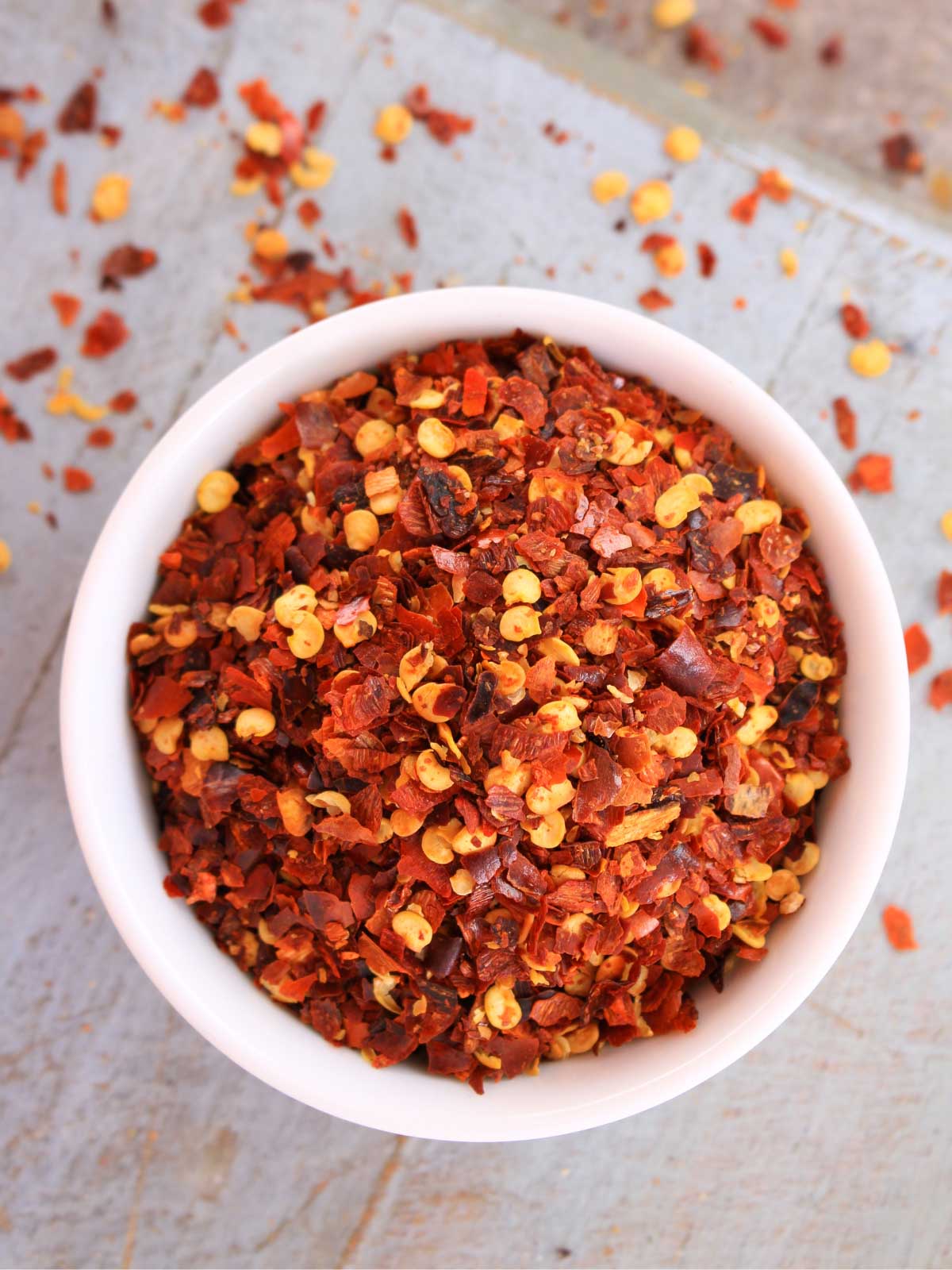 bowl of chili flakes on a white background