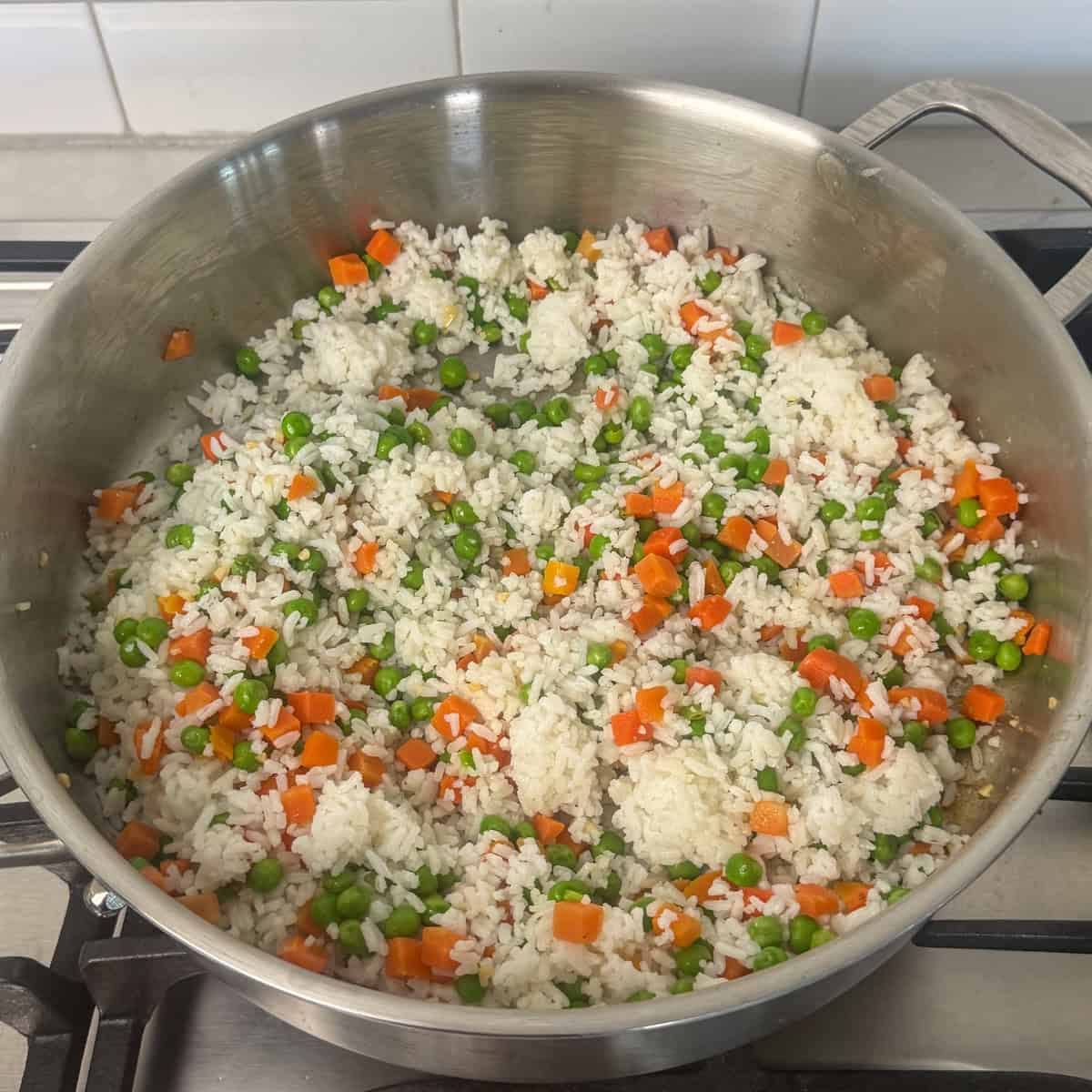 rice and veggies cooking in a skillet