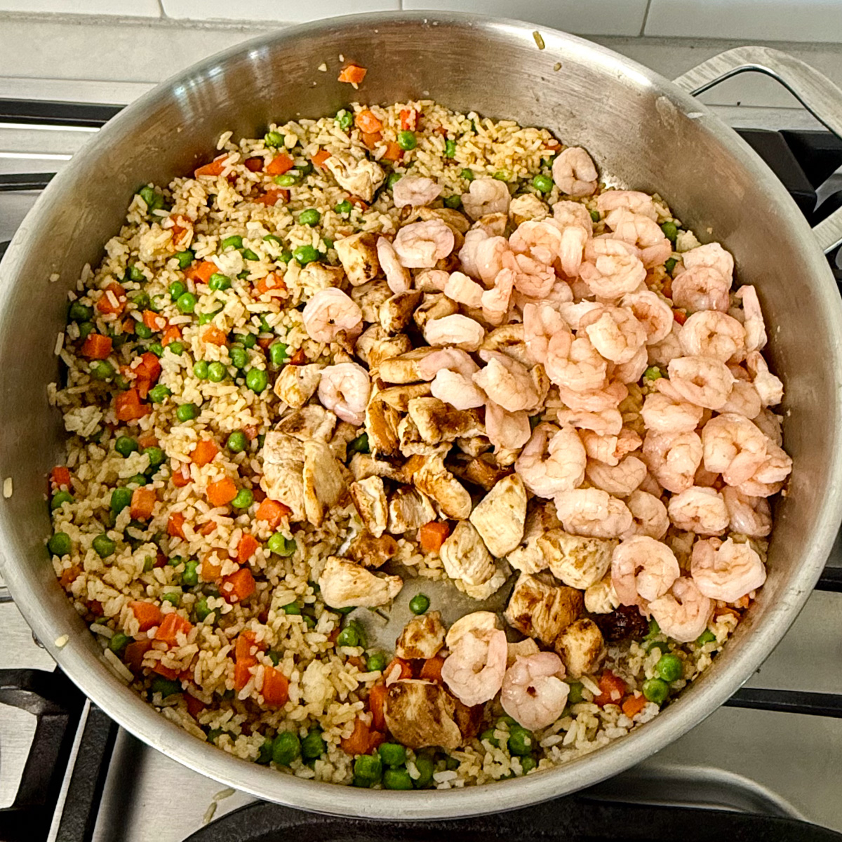 shrimp and chicken fried rice in a pan