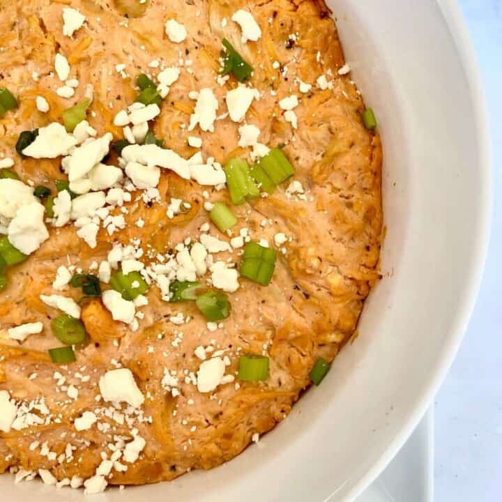 image of buffalo chicken dip with green onion garnish